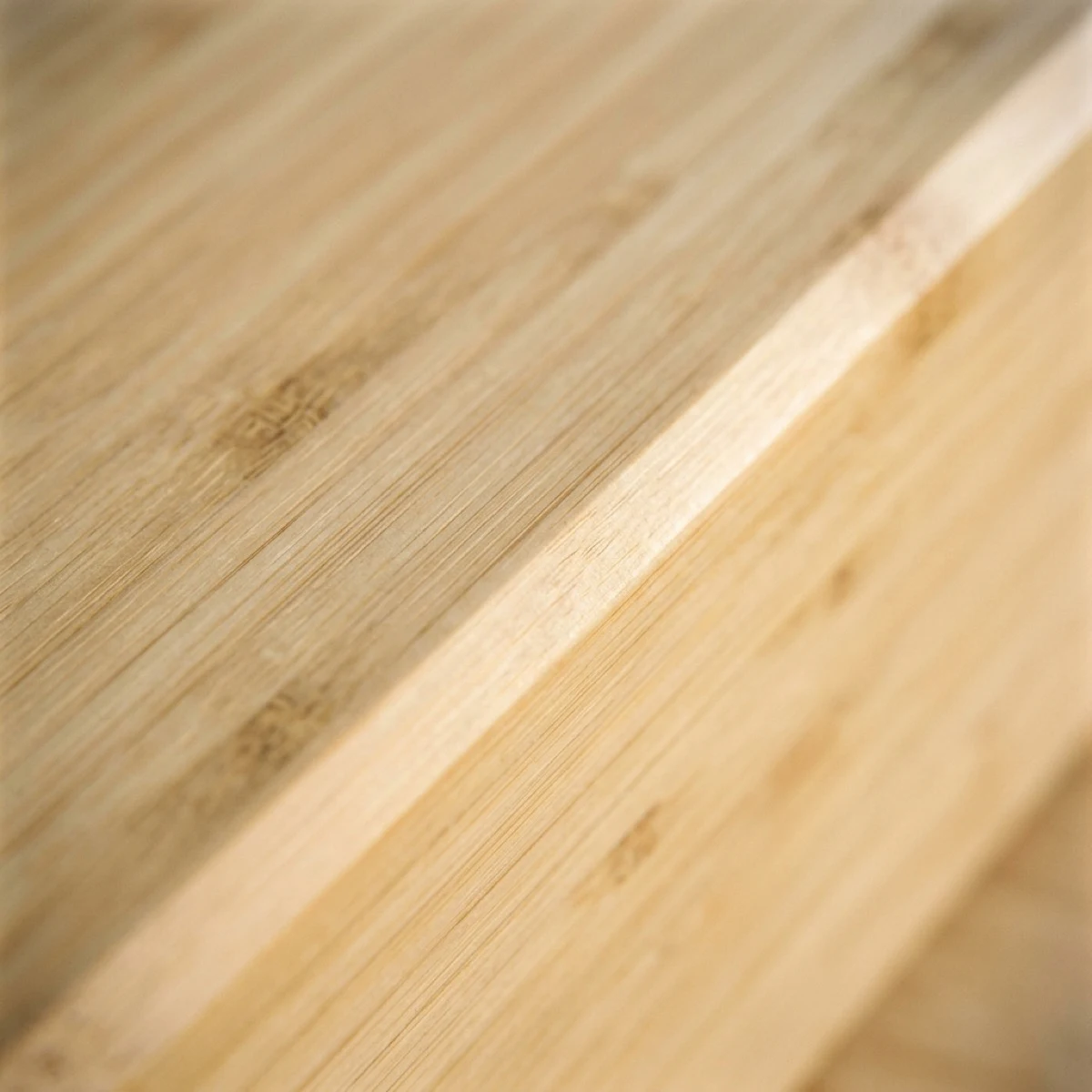 Macro detail of laminated bamboo — fine vertical grain and lamination lines at a softly chamfered edge