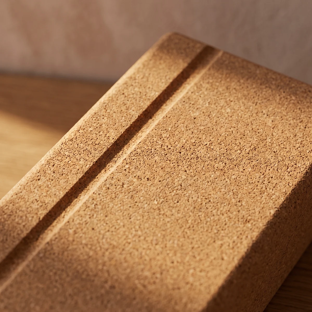 Macro detail of solid cork — dense natural granulate with a softly chamfered engraved edge